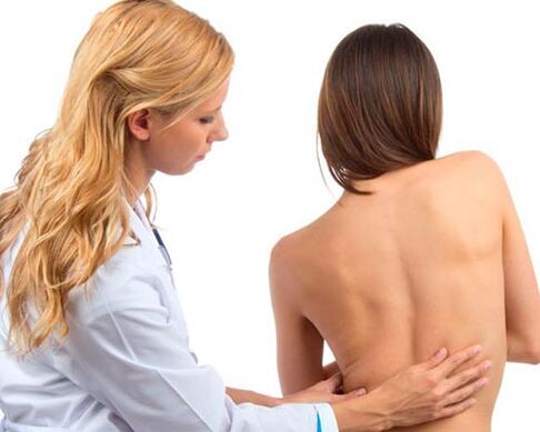 Doctor checks back for low back pain